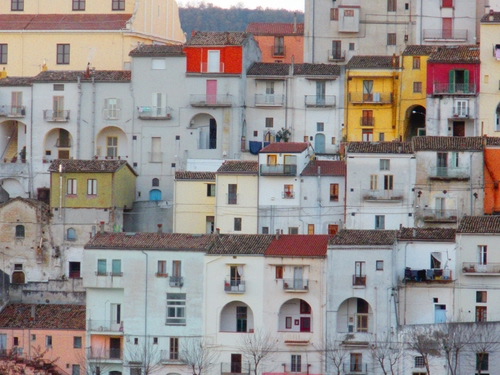 Immagine con finestre, case, tetti, archi, balconi, giallo, rosso, borgo, colori